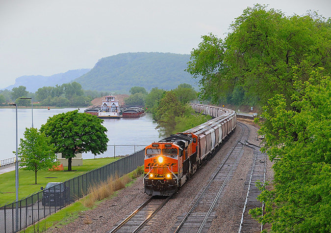 A grain shuttle travels along the Mississippi River near Alma, Wisconsin. A grain shuttle travels along the Mississippi River near Alma, Wisconsin.