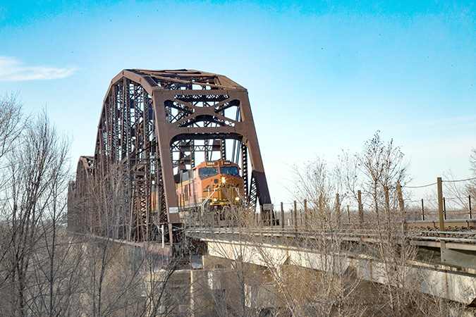 A BNSF train crosses the Missouri River rail bridge between Bismarck and Mandan.