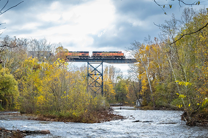 An all-BNSF consist leads a Norfolk Southern train over Elk Creek at Lake City, Pennsylvania. Photo by Mike Hauk. 
