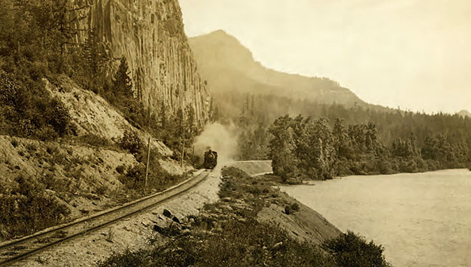 An SP&S train steams along the Columbia River near Beacon Rock in 1909.